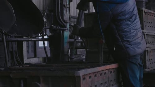 Industrial hard labor done by men in factory workshop.