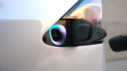 Hand Removing Charger from Electric Car