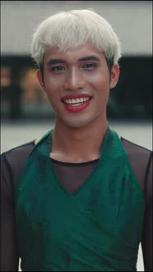 Vertical Video Young Transgender Man with Fashionable Haircut Posing Outdoors Dressed in Trendy