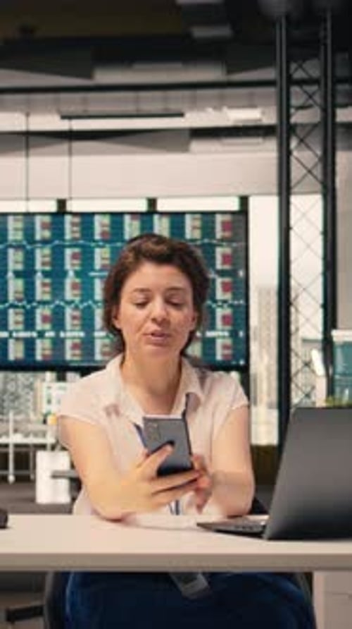 Vertical Video Smiling Woman Participating in Video Call From Workstation in Office