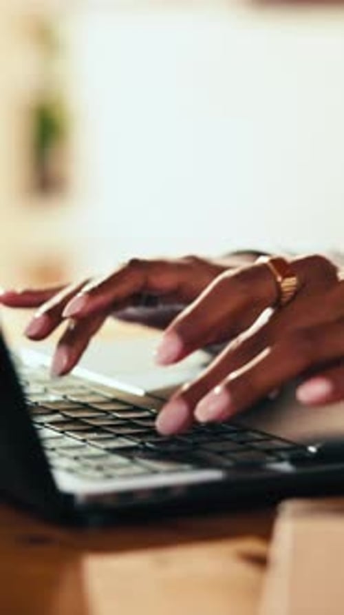 Woman's Hands Typing on a Laptop Keyboard