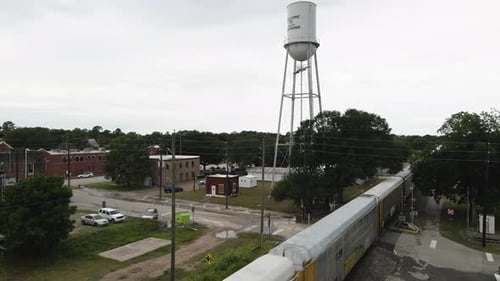 Freight Train Passes Water Tower In Small Texas Town