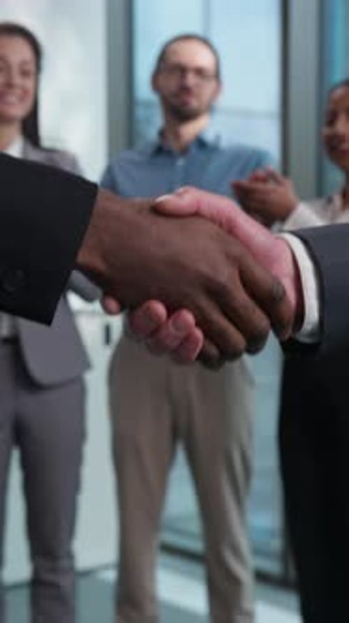 Business Deal Handshake with Team Celebration
