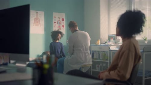 African Teen Girl Visit Doctor Office With Mom. Man Physician Checkuping Preteen In Mother Presen...