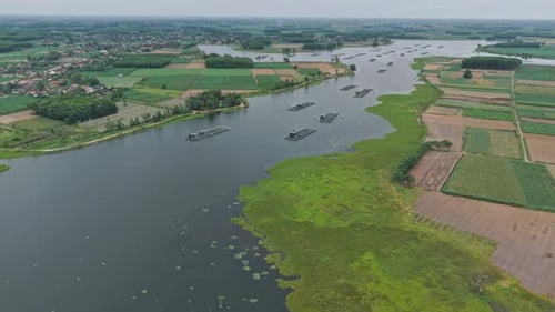 Aerial View Of A River With Aquaculture Structures And Farmland