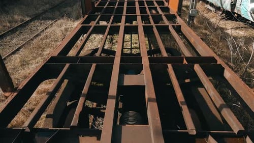 Flying inside an old rusted wagon train in an abandoned train deposit