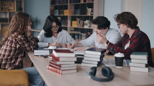 Diverse students studying and collaborating together in a college library