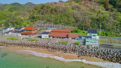 Panning Aerial View of a Japanese Coastal Village and Tunnel