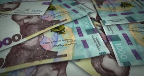 Ukraine Hryvnia 1000 banknote flying over money surface