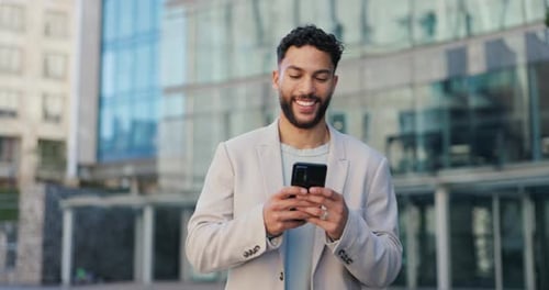 Phone, smile and happy businessman walking in a city with social media, scroll or web chat outdoor