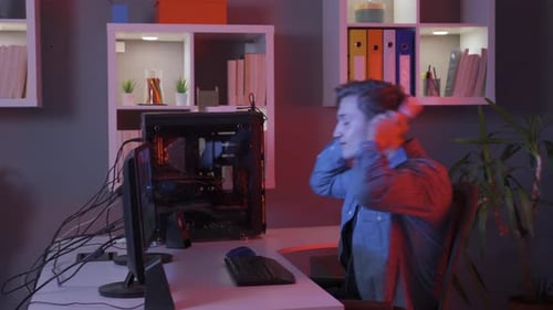 Excited Young Gamer Playing Computer Game at Home