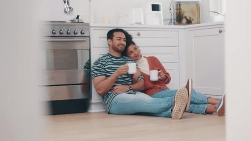 Loving Couple Relaxing with Coffee in Kitchen