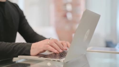 Close Up of Man Typing on Laptop