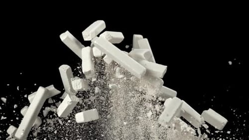 School Chalk Flies Up and Falls Down on a Black Background Filmed on a Highspeed Camera at 1000 Fps