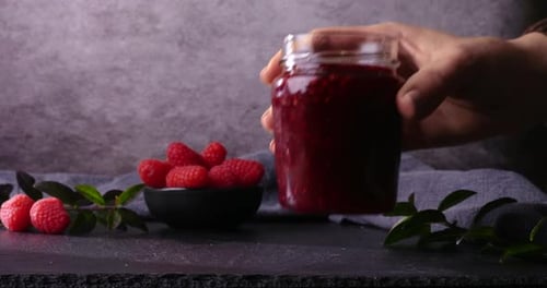 Raspberries and Jam on Countertop in Home