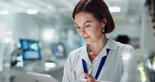 Scientist Using Tablet in Bright Modern Lab