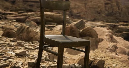 Lonely Wooden Chair Positioned on Rocky Terrain During Daytime