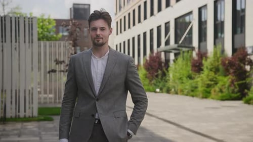 Confident Young Adult Male in Gray Suit Outdoors