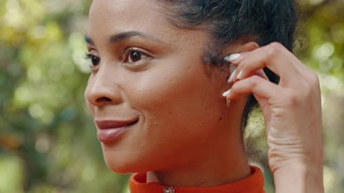 Wireless earphones and music of woman running and listening in park, garden