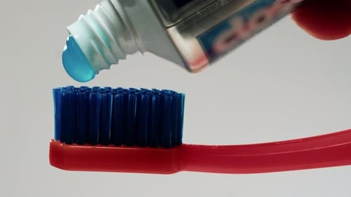 Blue Toothpaste Applying on Brush Against White Background Morning Medical Tooth Paste
