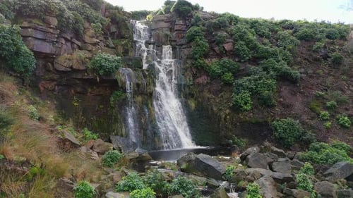 Aerial drone footage of a tall rocky waterfall in the Yorkshire Dales, Pennies. Moorland scene of a