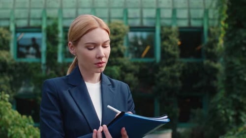 Portrait Pensive Businesswoman in Formal Suit Writes Something with Pen in Folder with Documents