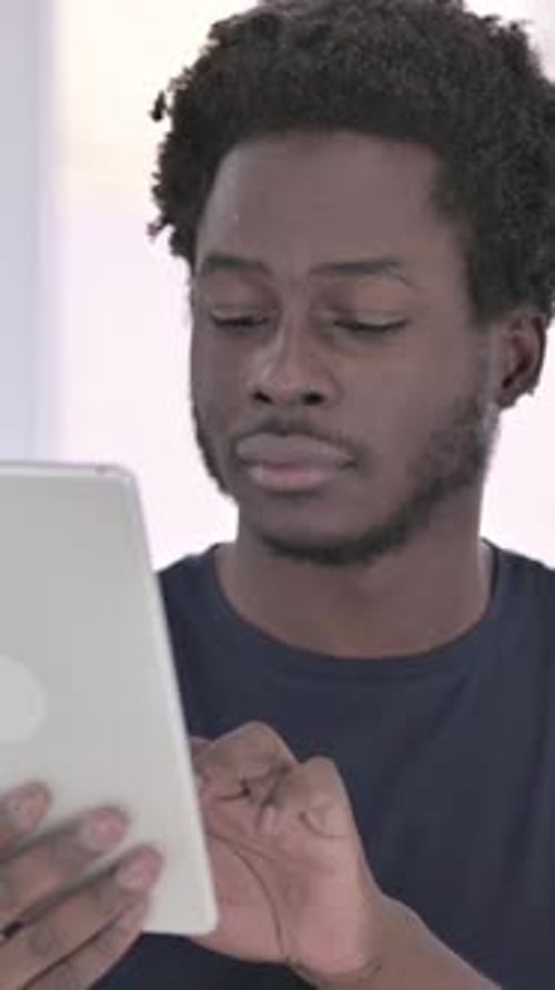 African Man using Tablet in Office, vertical video
