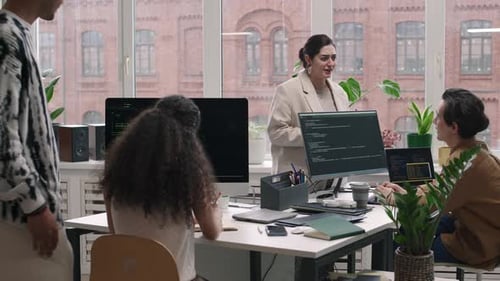 Team of Young Programmers Co-working in Modern Office