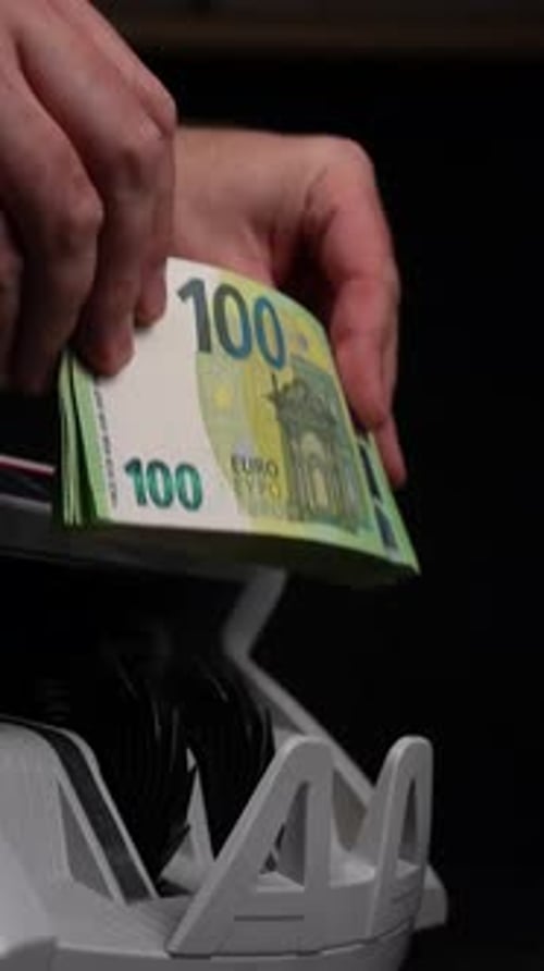 Stack of 100 Euro Notes Placed in Counter