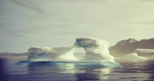 Majestic Ice Arch Rises Above Calm Waters in Remote Arctic Landscape