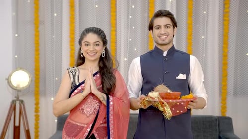 Indian couple standing in front of temple