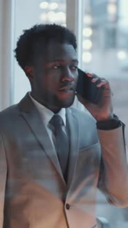African American Businessman Talking on Mobile Phone in Office