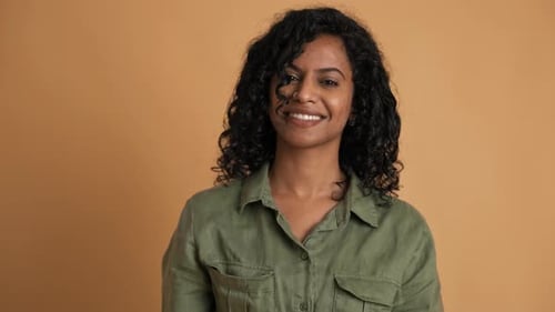 Young Woman Smiling at Camera in Studio Setting