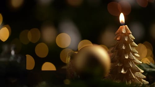 Christmas Tree Candle with Festive Bokeh Background