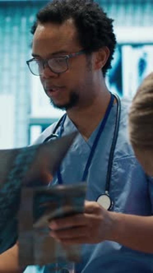 Medical Professionals Reviewing X-Rays in Hospital Office