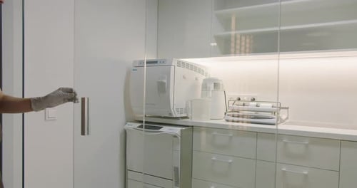 Medical Professional Enters Modern, Clean Laboratory