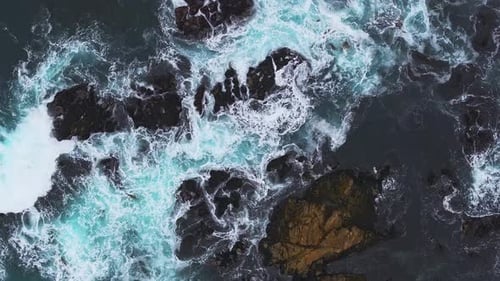 Aerial View of the Pacific Ocean Waves Hitting the Cliff Rocks