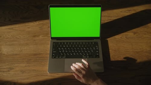 Top View Caucasian Woman Hand Entering Frame and Scroll Down on Laptop Touchpad with Green Screen