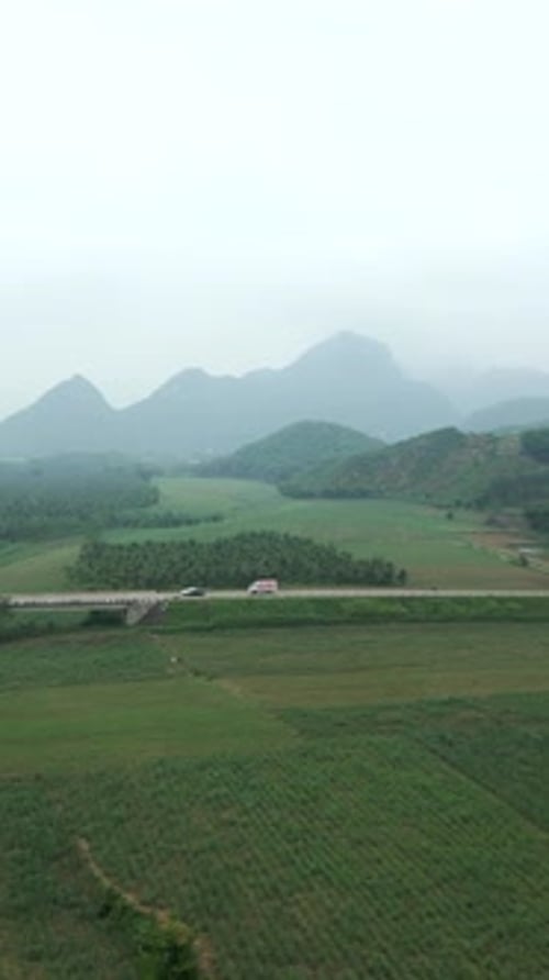 a Long Bridge Crosses the Big River Between the Valley and the Mountains in the Forest of Vietnam