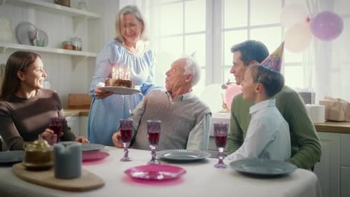 Family Birthday Celebration With Cake and Festive Cheer