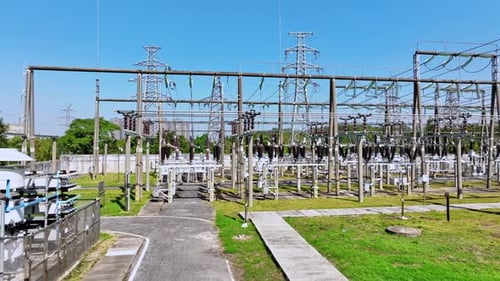 aerial view electric substation, pylon power line high voltage, electrical transmission field,