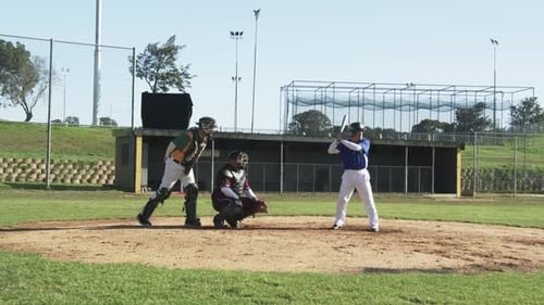 Baseball Players Practicing on the Field During the Day