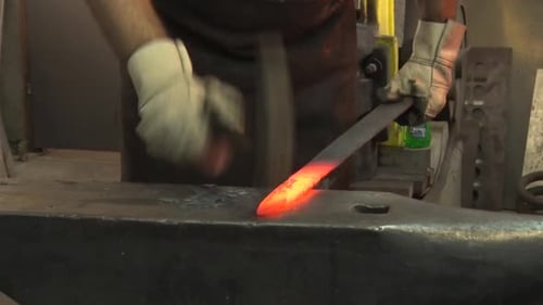 Blacksmith Forging Red Hot Metal on Anvil