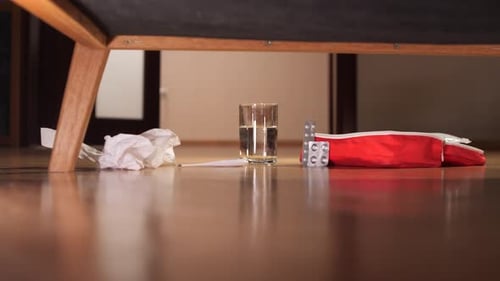 Hand Placing Thermometer Next to Water