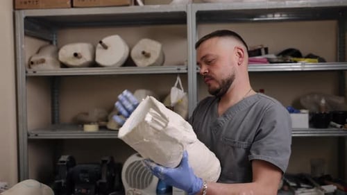 Man Inspecting a Hardened White Medical Cast