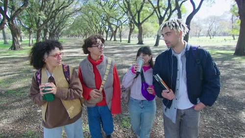 Friends Walking in Park Alley and Discussing Study Day after College
