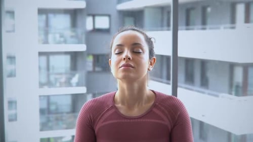 Woman Meditating in Lotus Position at Her Apartment