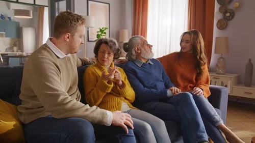 Family of Four Sitting Together on Couch