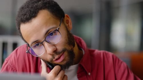Steadicam Shot Young Multiethnic Male Teacher Business Education Coach Talks on Phone in Library