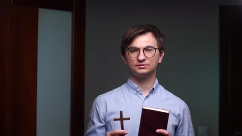Man Holding Cross and Book
